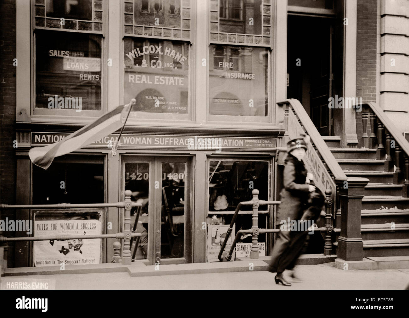 A woman walks by National American Woman Suffrage Association building. Circa 1913. Stock Photo