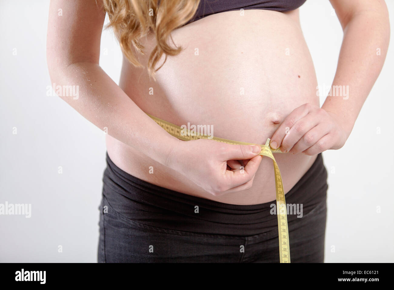 Young Pregnant Woman Misses Your Belly With A Tape Measure