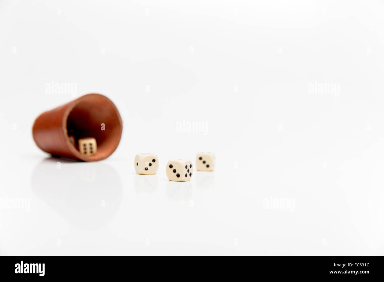 Dice cup, cube, Yahtzee, all good things come in threes Stock Photo Alamy