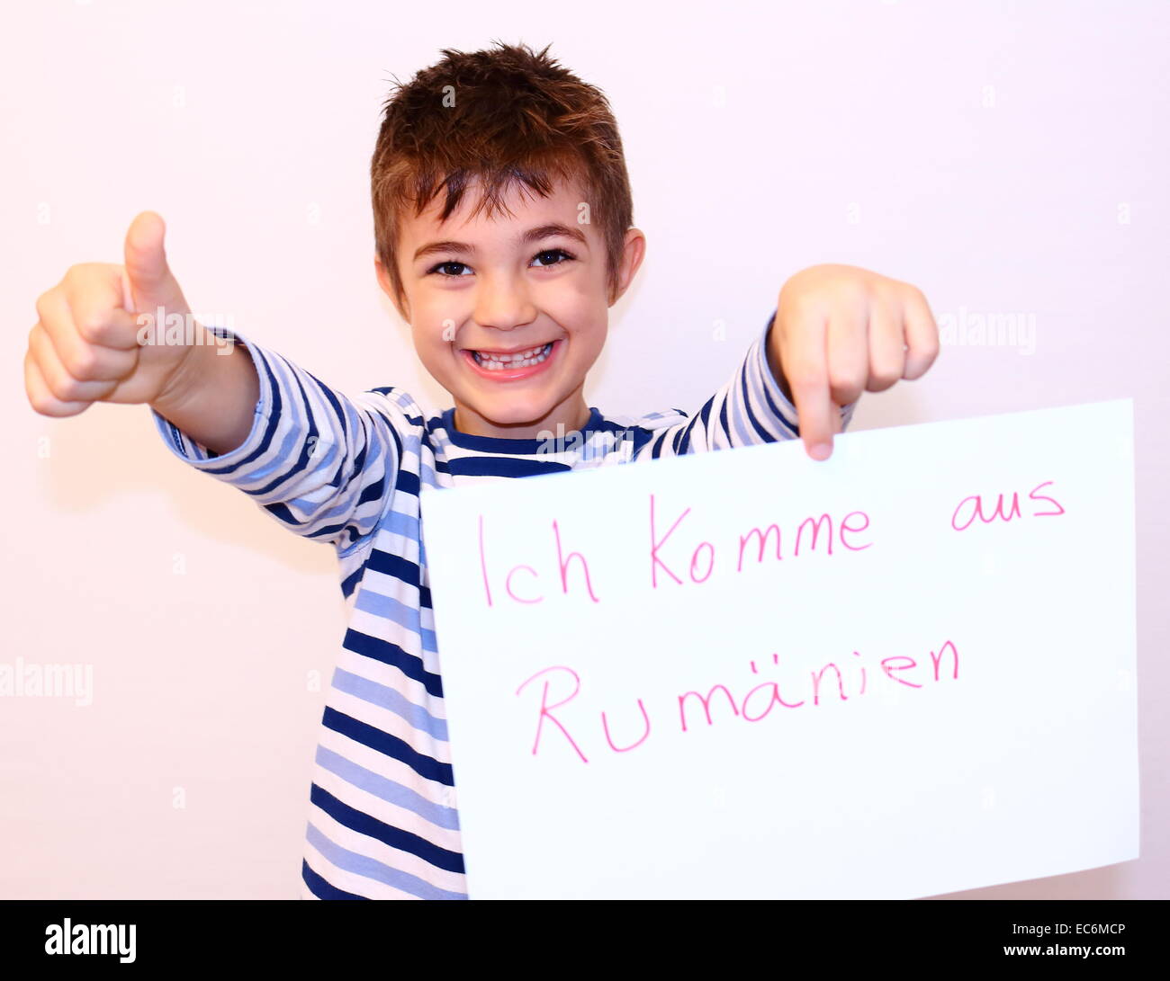 Child shows sign with I am from Romania Stock Photo