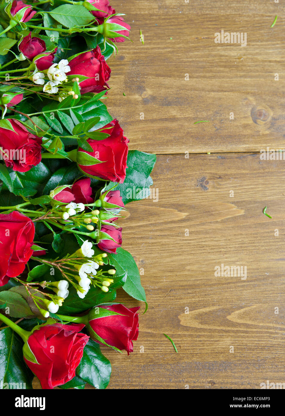 Rustic wooden background with red roses Stock Photo Alamy