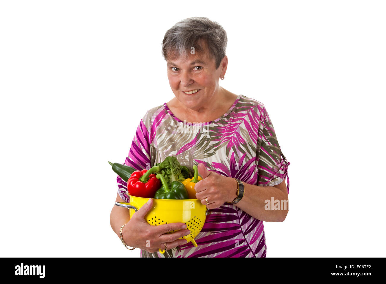 Senior woman presenting a basket of vegetables Stock Photo - Alamy