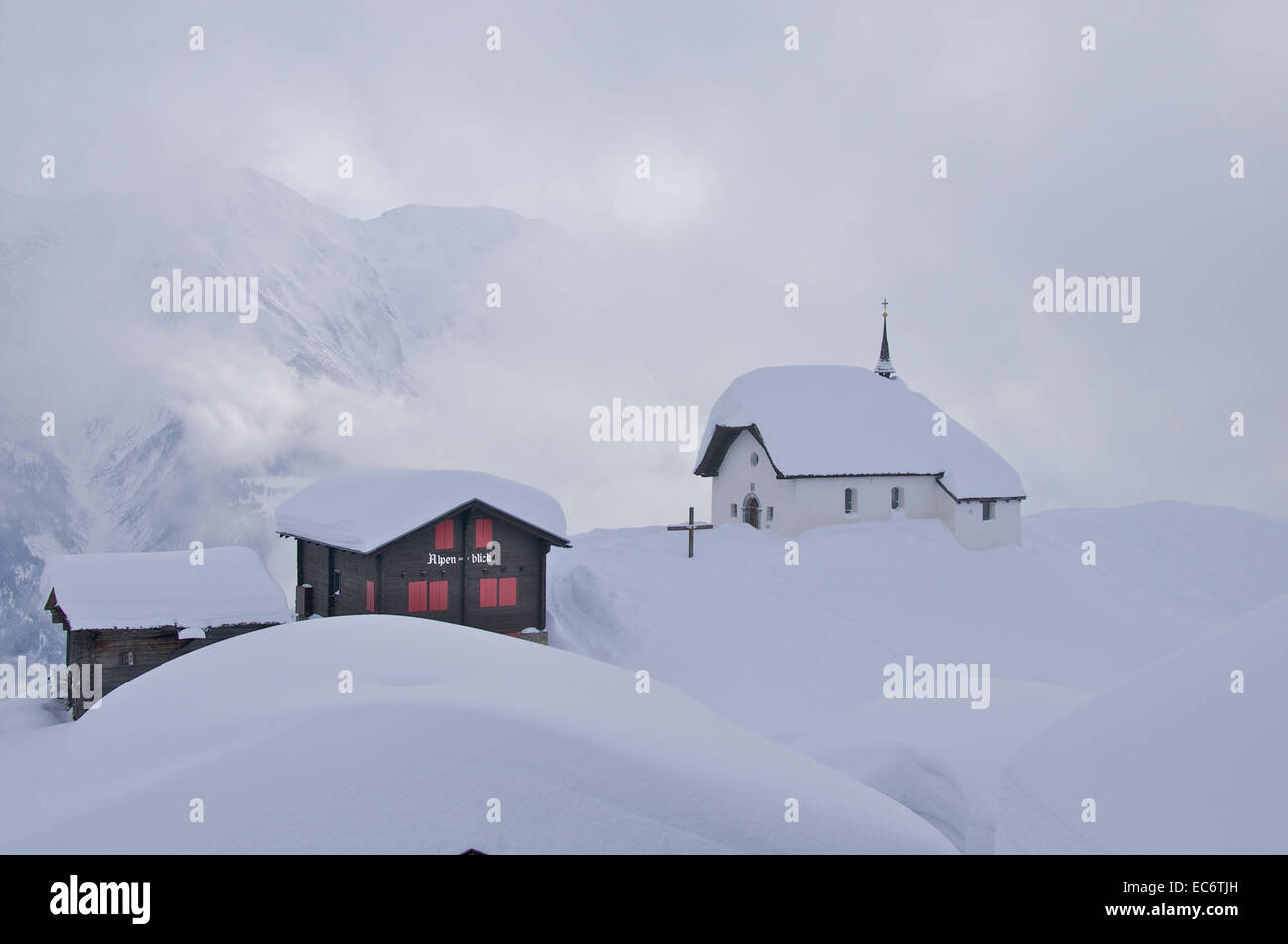 snowy chapel maria zum schnee, Bettmeralp, wafts of mist, sun ray Stock Photo