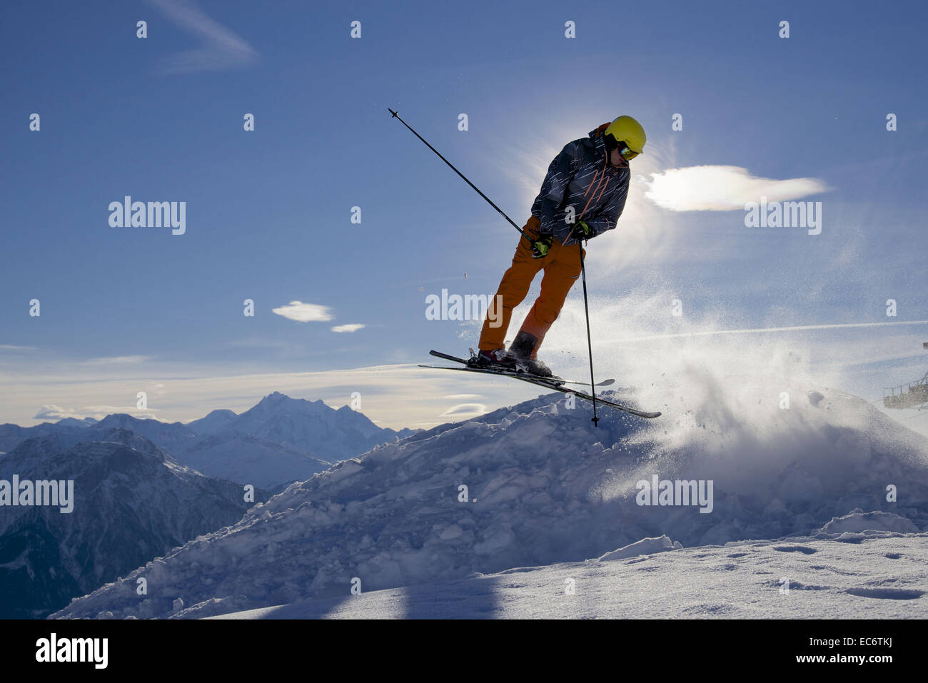 jumping freeskier in the mountains, silhouetted Stock Photo