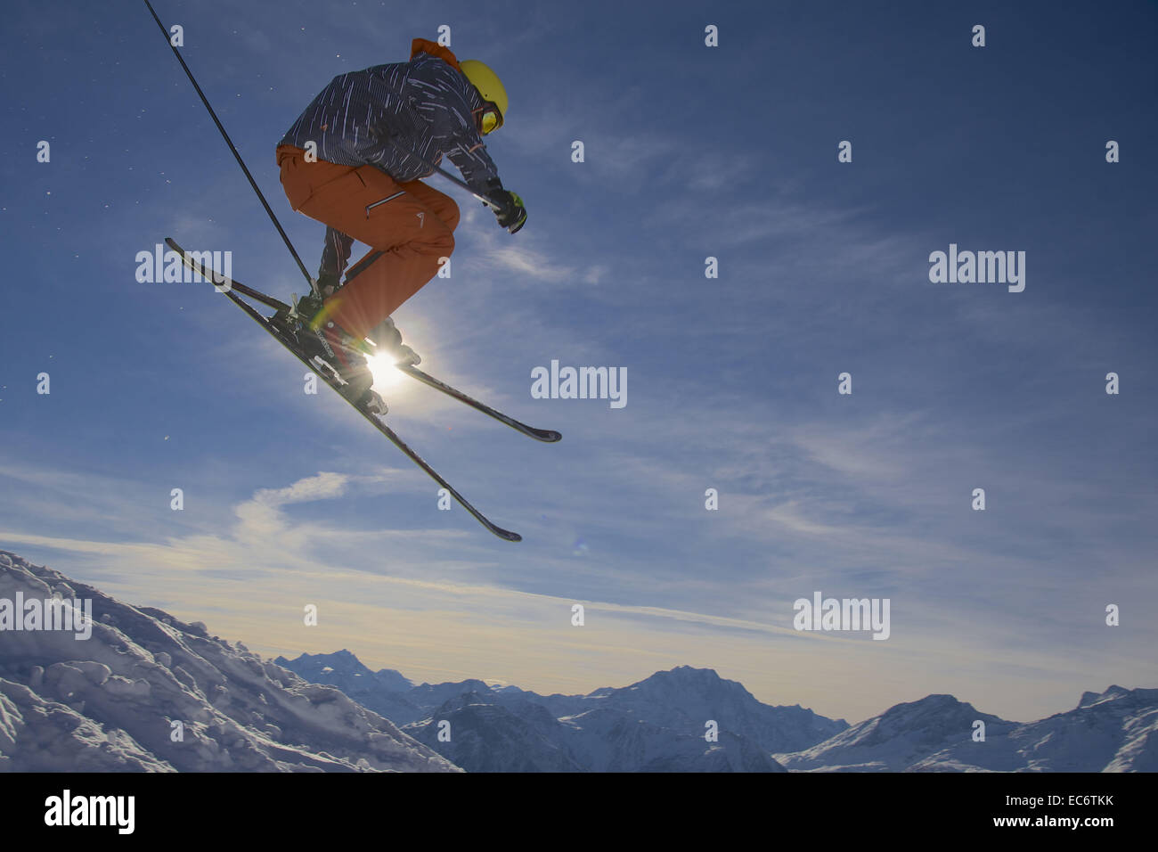 jumping freeskier in the mountains, silhouetted Stock Photo