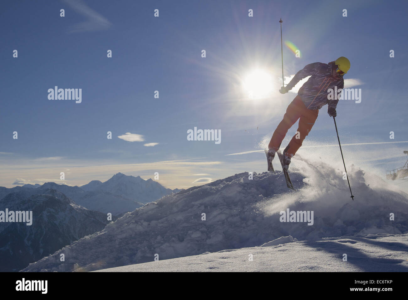 jumping freeskier in the mountains, silhouetted Stock Photo