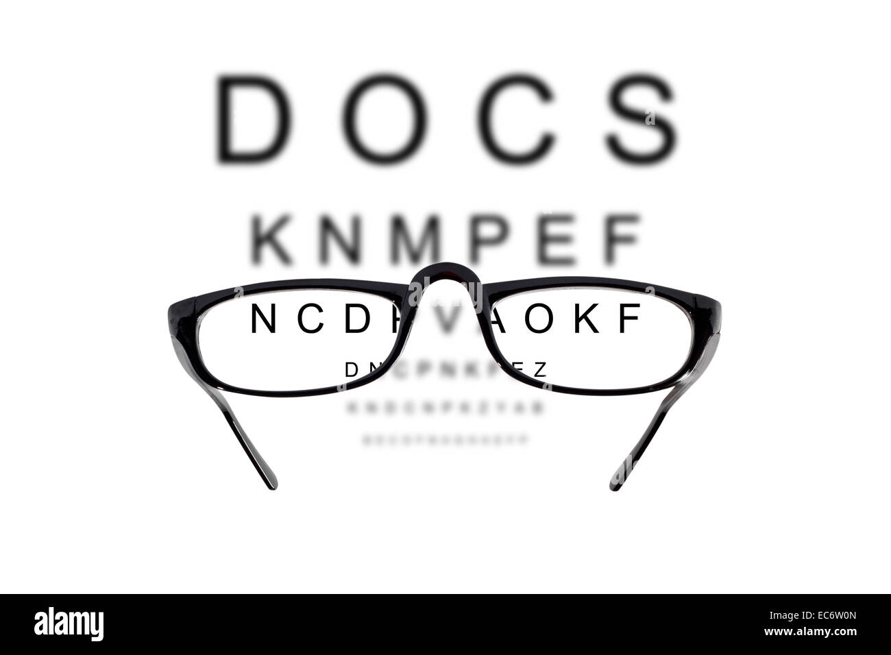 Eyeglasses over blurry background of letters Stock Photo