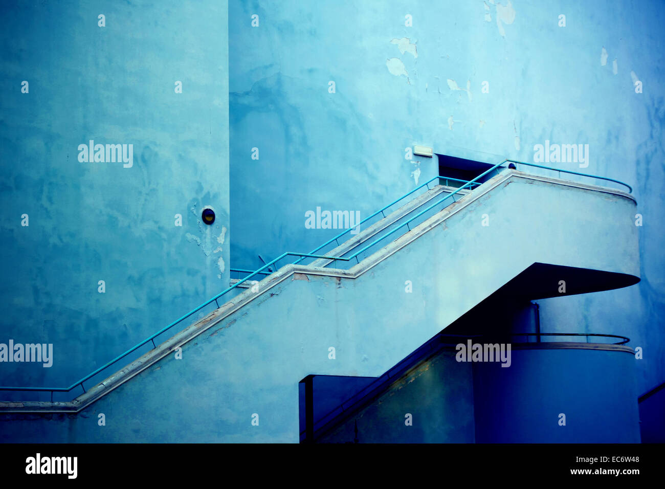 House facade with external staircase in blue tones with a slight vignette, Italy Brescia Stock Photo