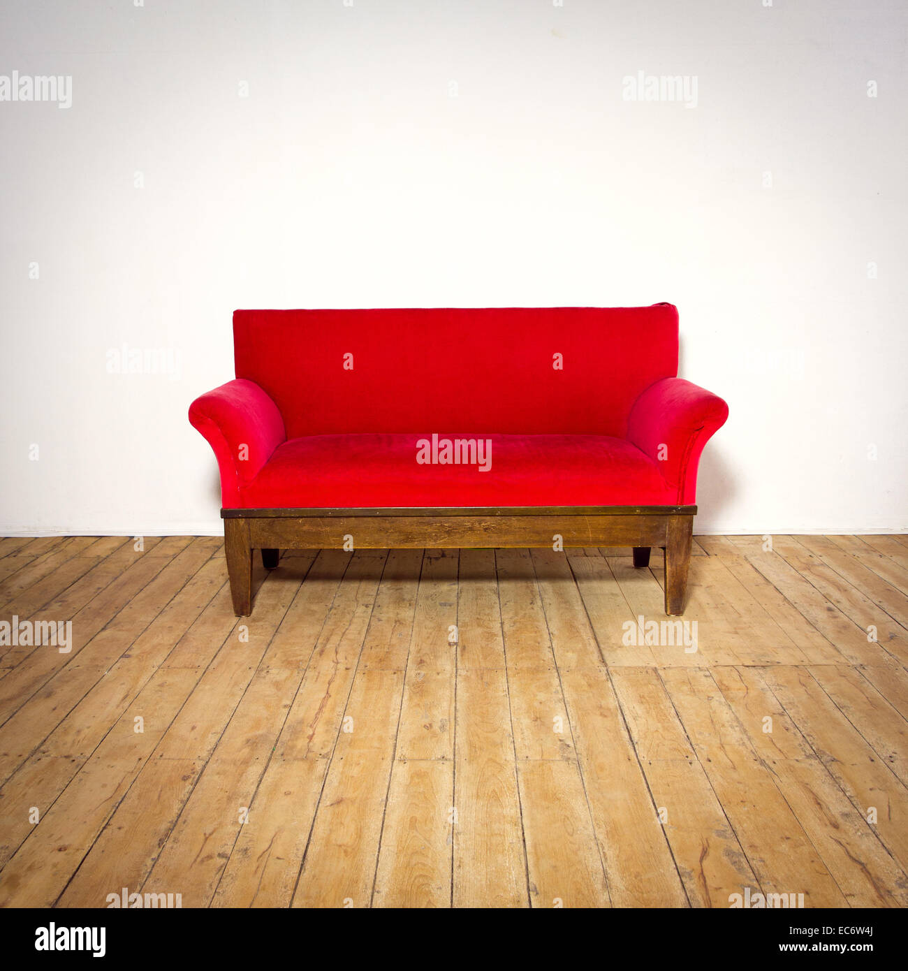 Antique red sofa on old wood floor background white wall studio shot Stock Photo