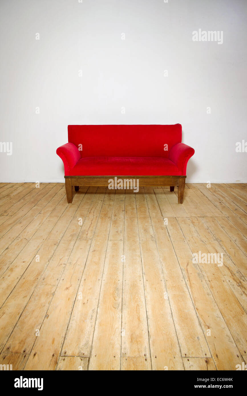 Antique red sofa on old wood floor background white wall studio shot Stock Photo