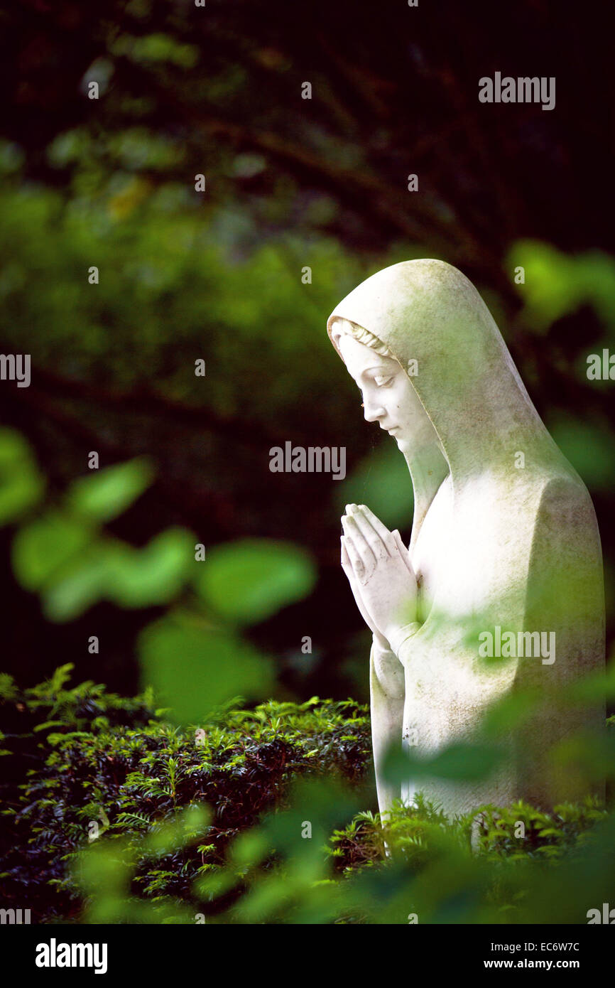 Praying Mary statue in the open Stock Photo