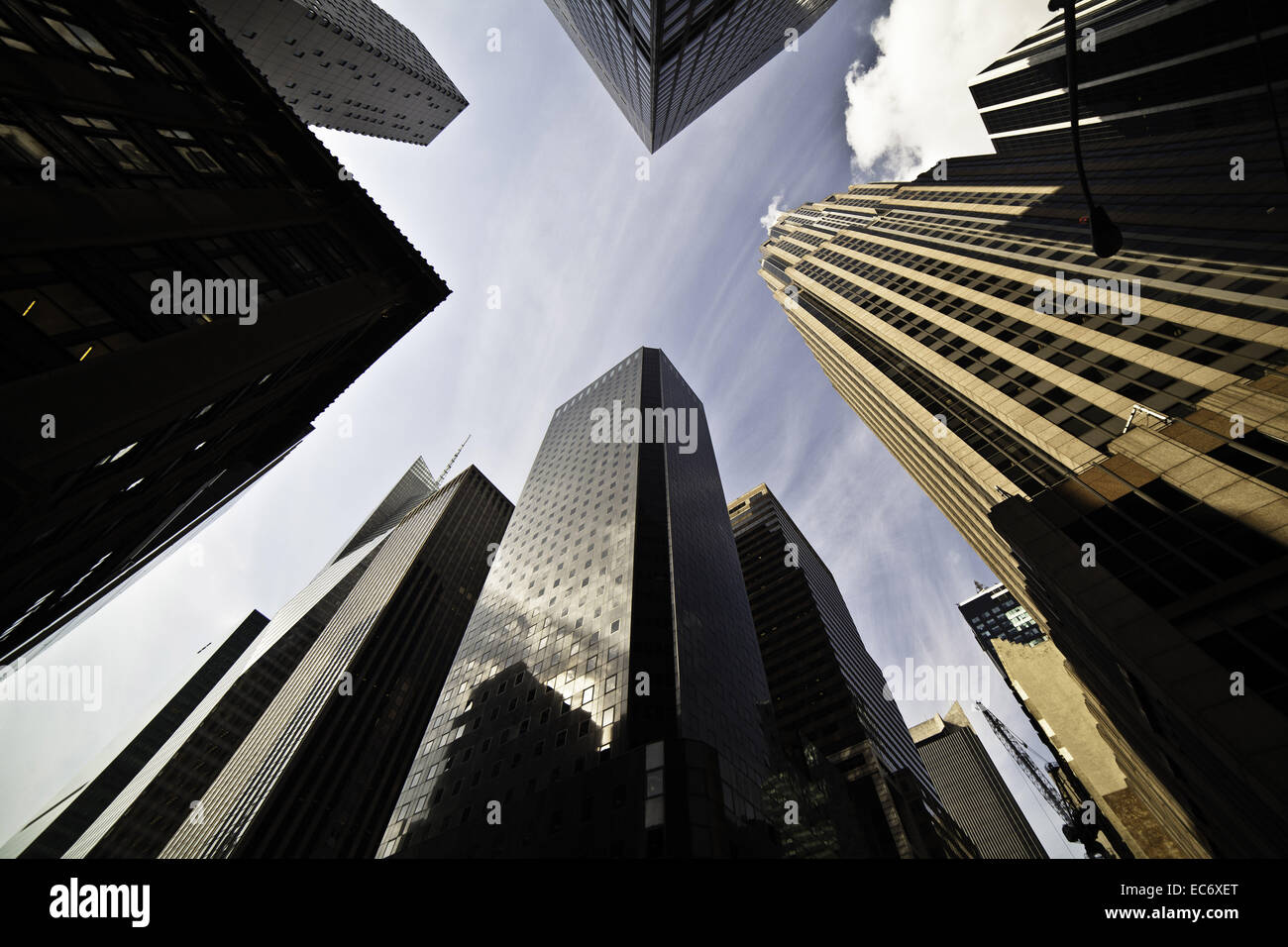 Looking up between the skyscrapers in NewYork City into the sky. Extreme perspective.Frog perspektive. Stock Photo