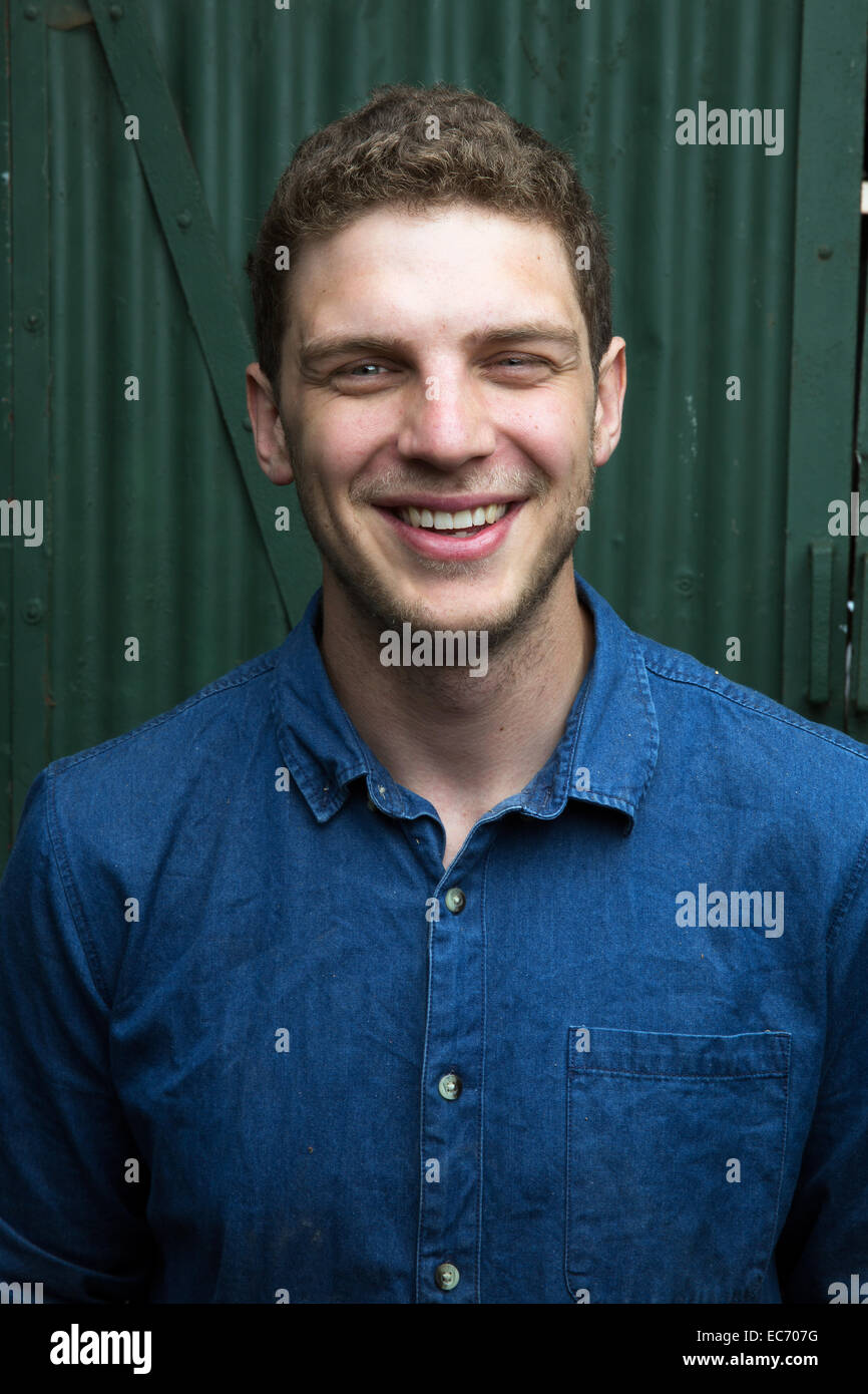 Portrait of a 24 year old carpenter/shipwright in front of his workshop in London, England. Stock Photo