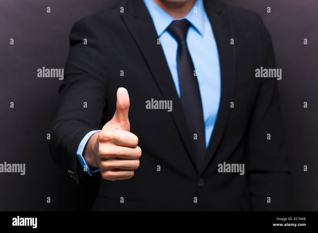 Businessman showing thumbs up sign Stock Photo