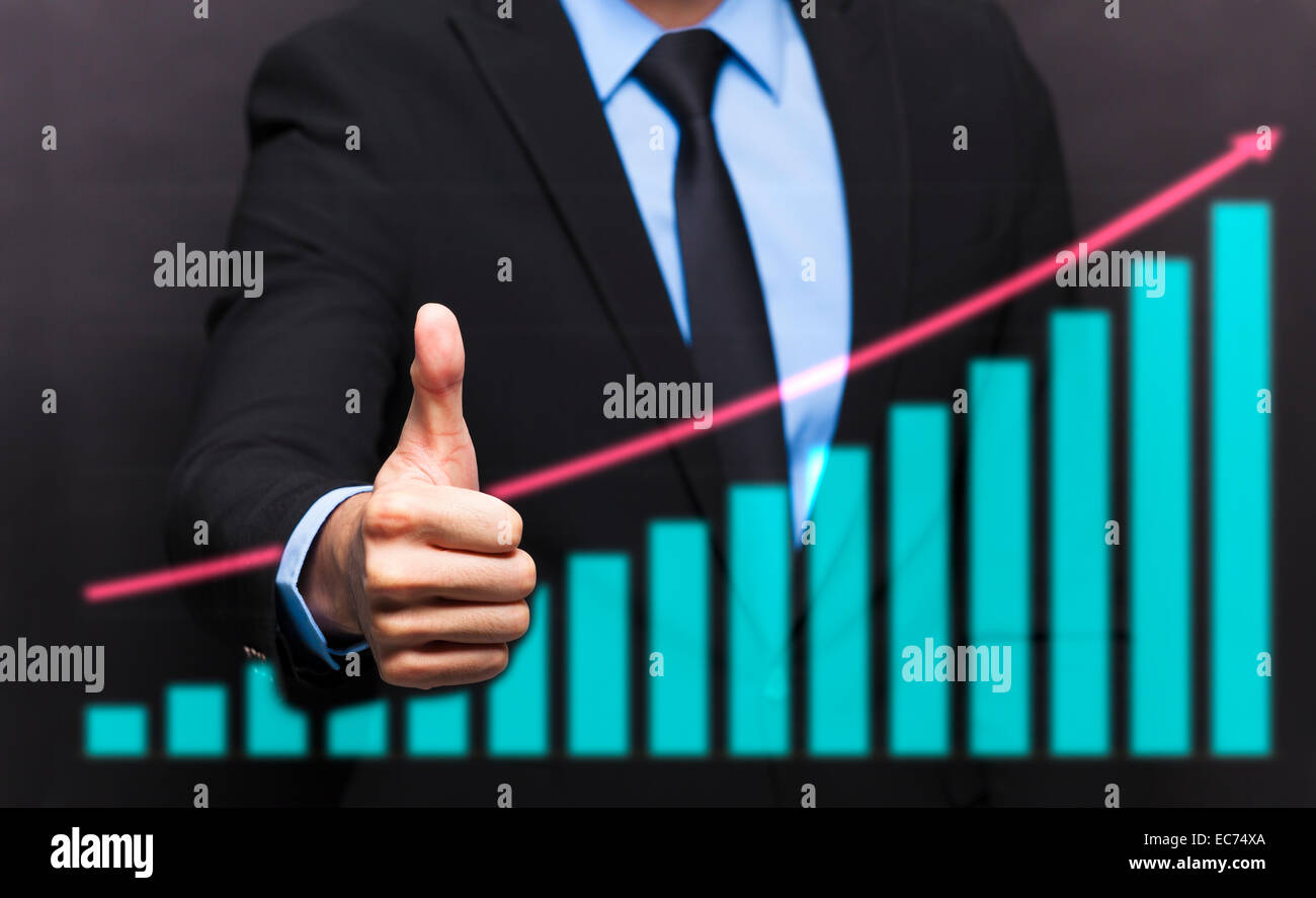 businessman with thumb up gesture and business growing graph concept Stock Photo