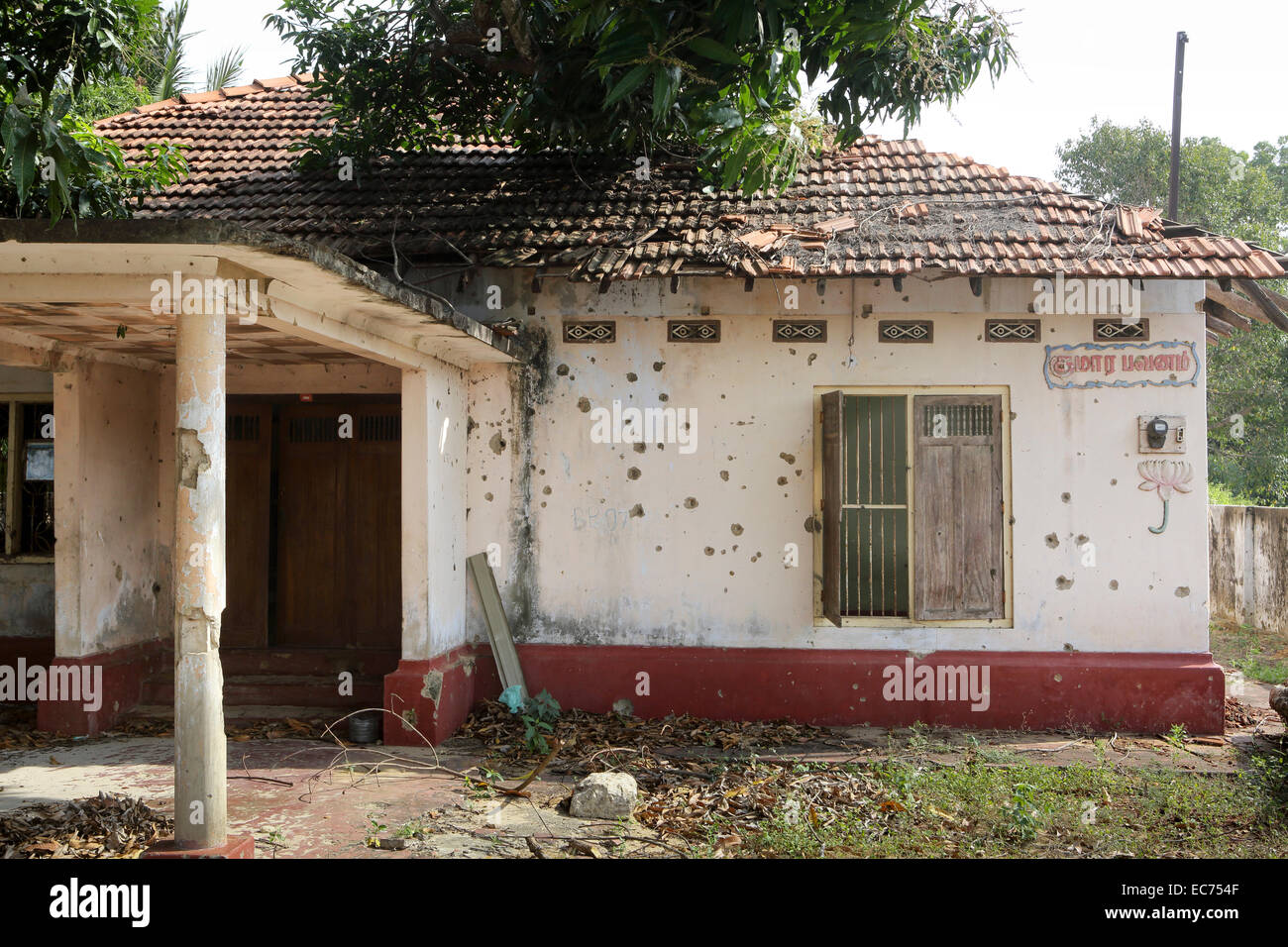 Abandoned house full of holes from machine gun fire from the civil war in Jaffna, Sri Lanka Stock Photo