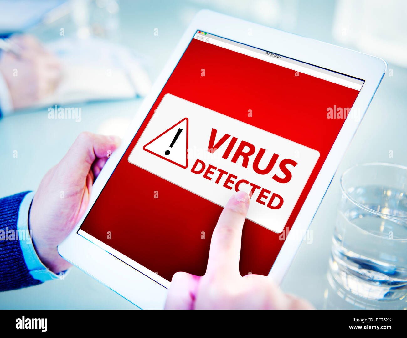 Man Using a Digital Tablet with Virus Stock Photo