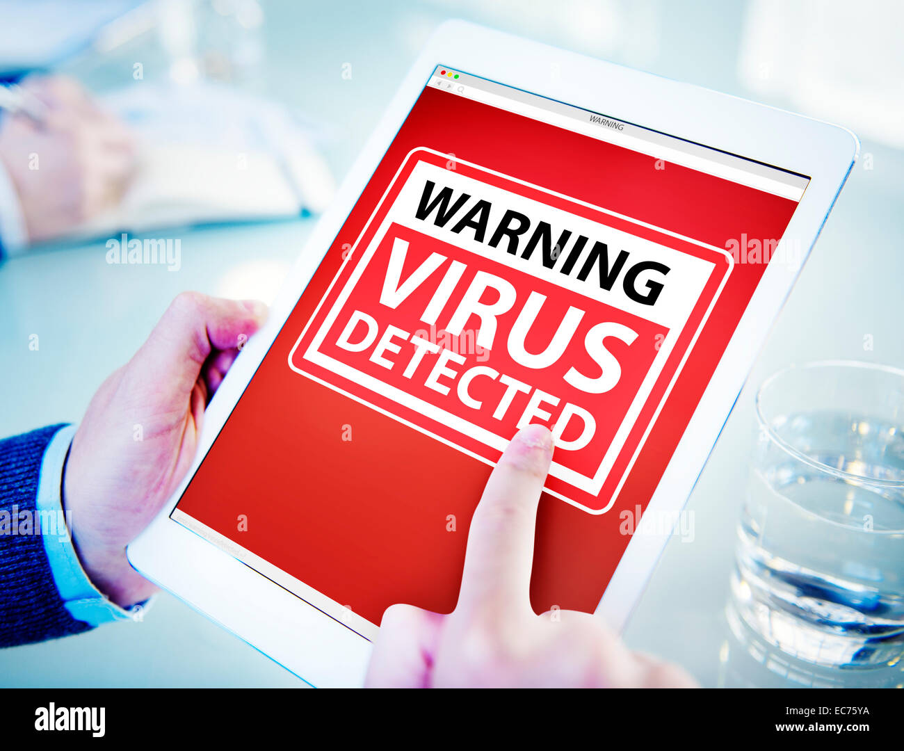 Man Using a Digital Tablet with Virus Stock Photo