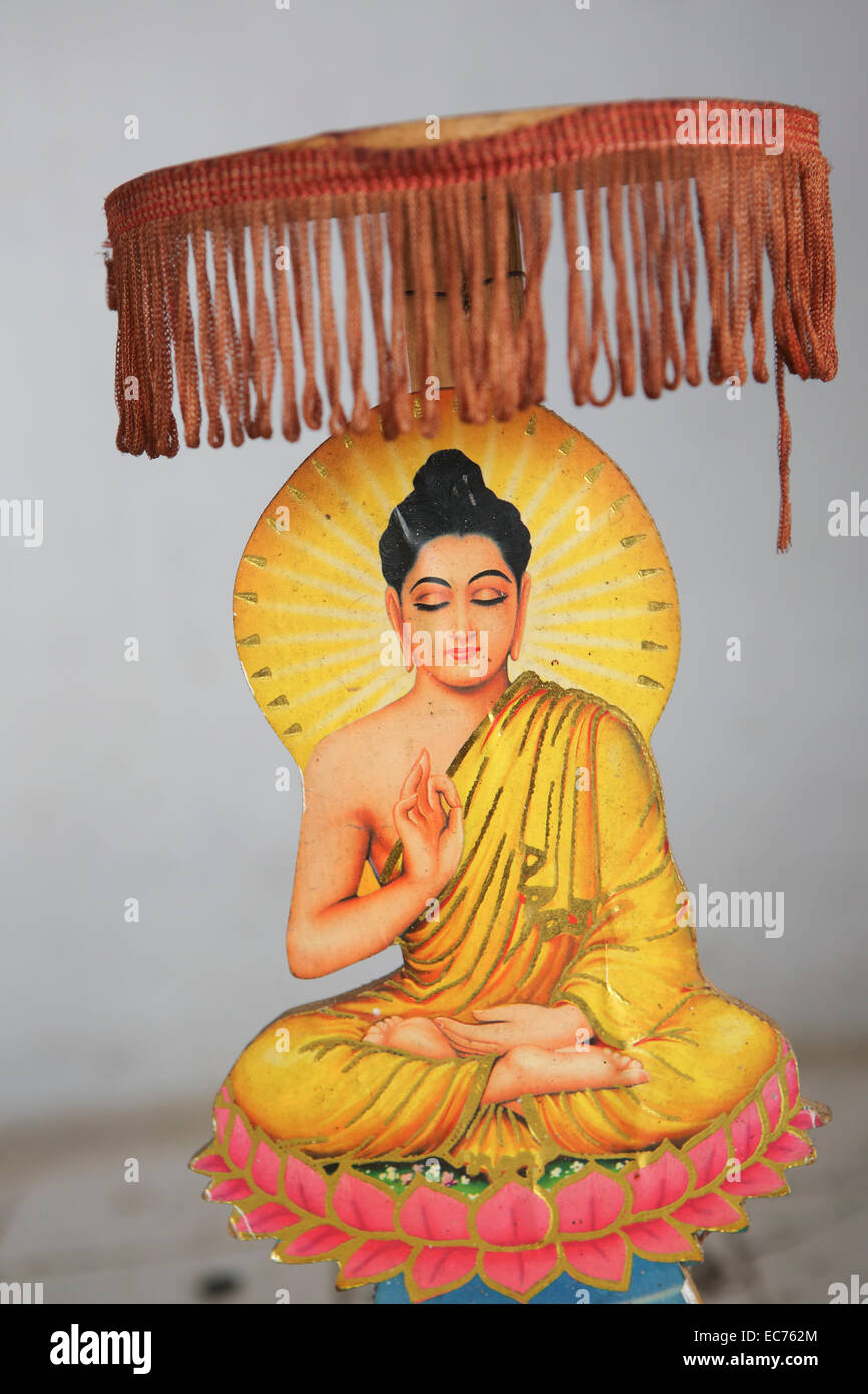 Small Buddhist carving sitting in lotus position at temple Stock Photo