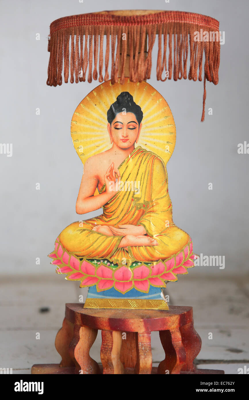 Small Buddhist carving sitting in lotus position at temple Stock Photo