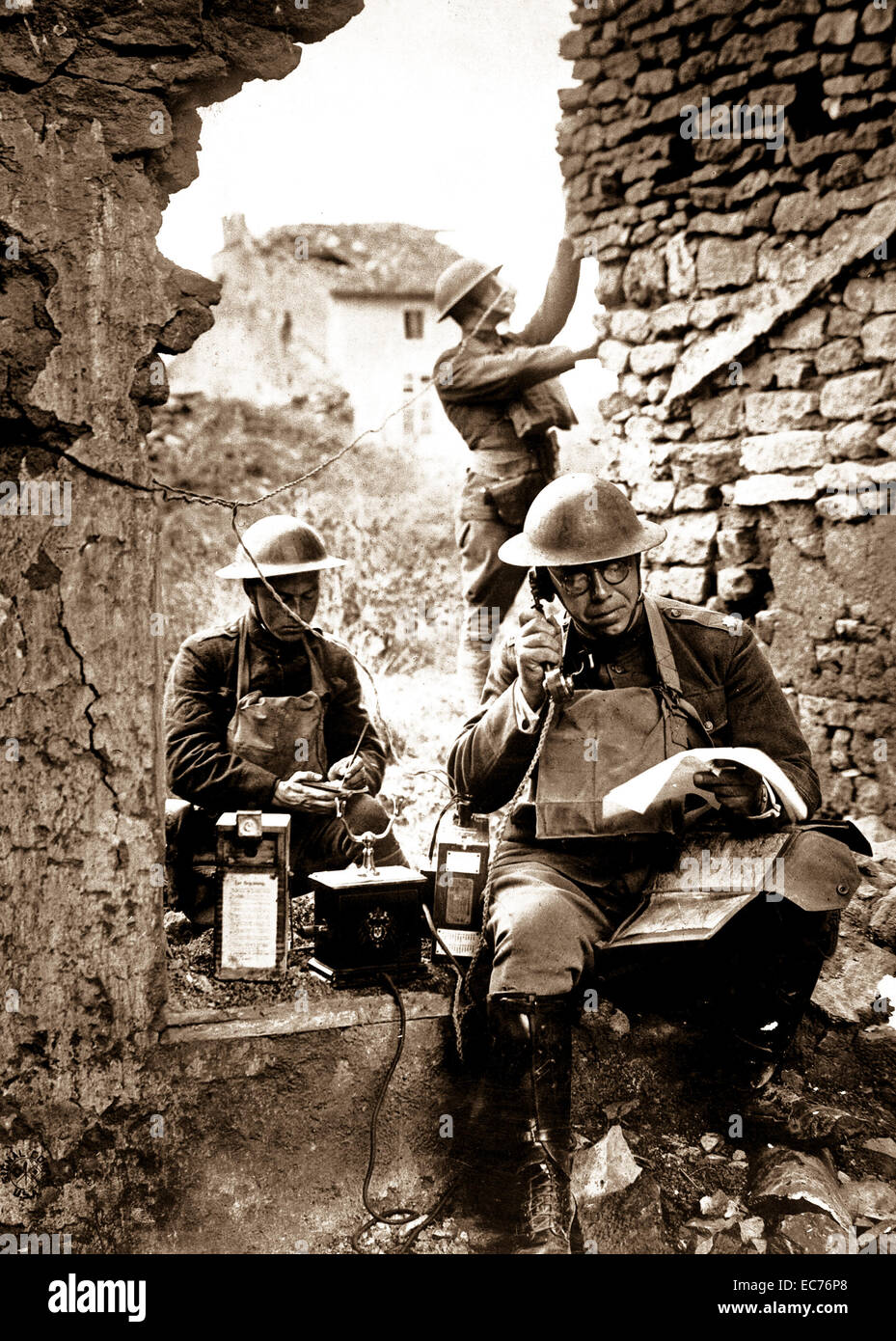 Lt. Col. R. D. Garrett, chief signal officer, 42nd Division, testing a telephone left behind by the Germans in the hasty retreat from the salient of St. Mihiel.  Essey, France.  September 19, 1918.  Cpl. R. H. Ingleston. Stock Photo
