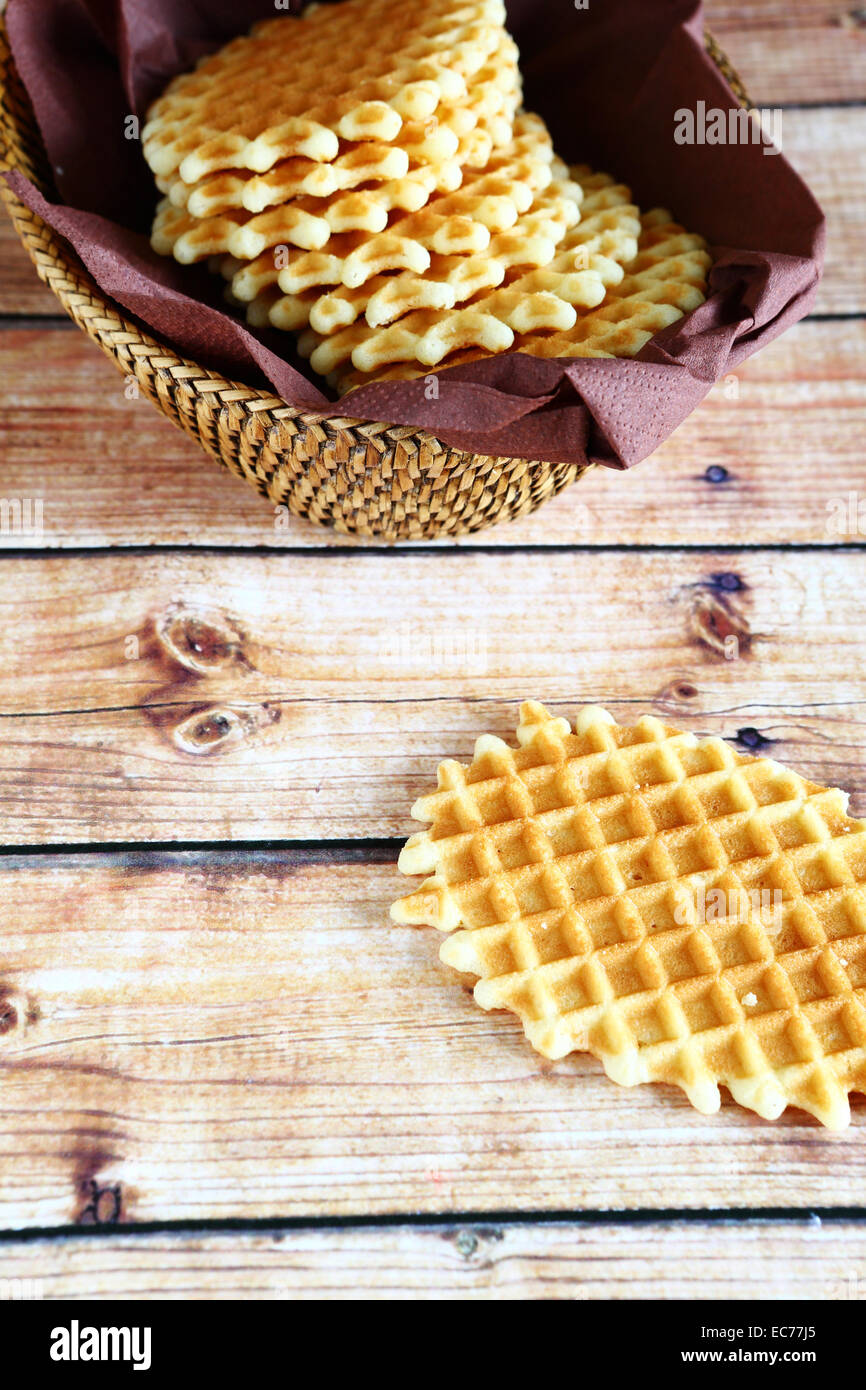 Wafers in a wicker basket on a wooden boards Stock Photo