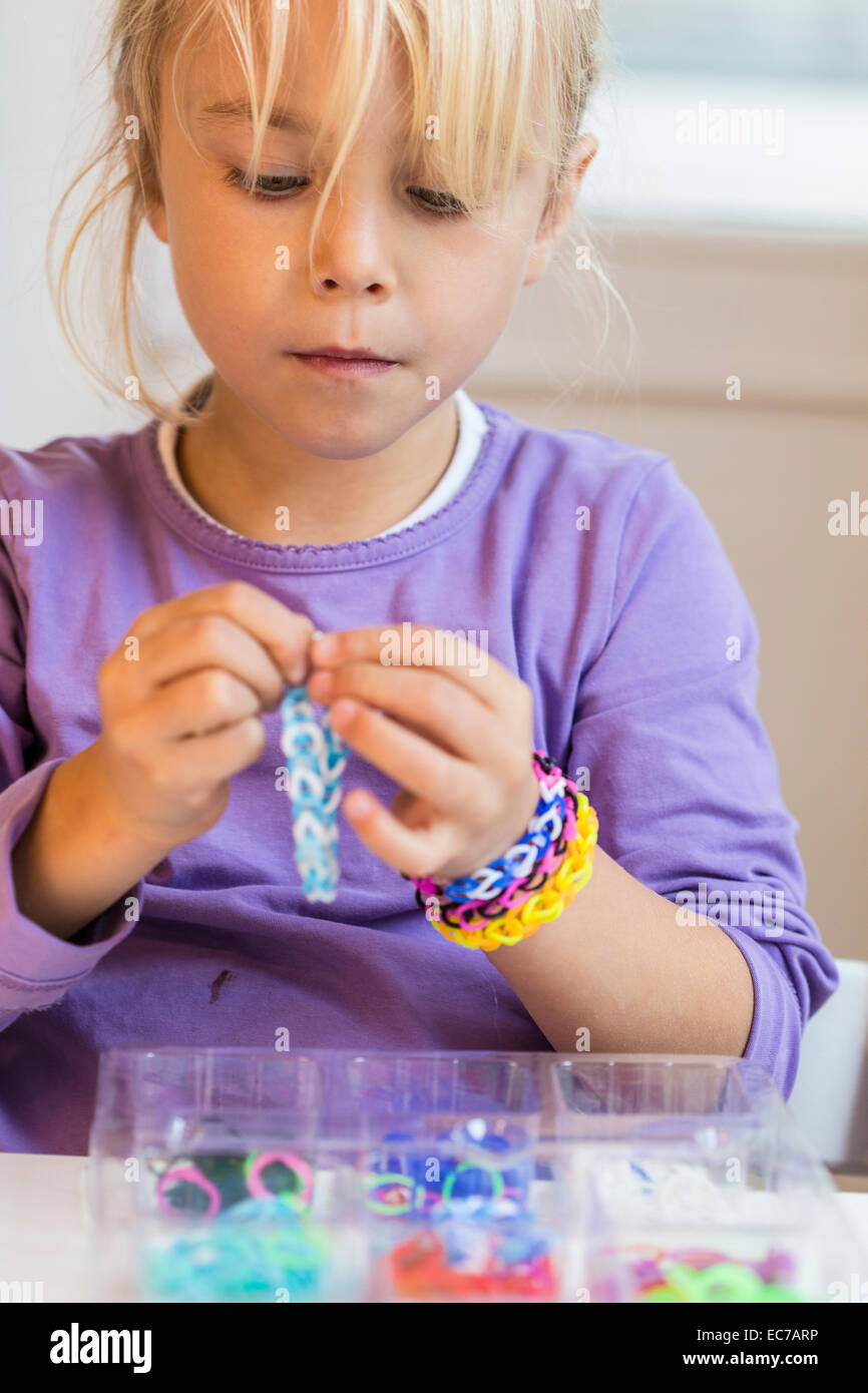 Portrait of little girl making loom bracelets Stock Photo Alamy