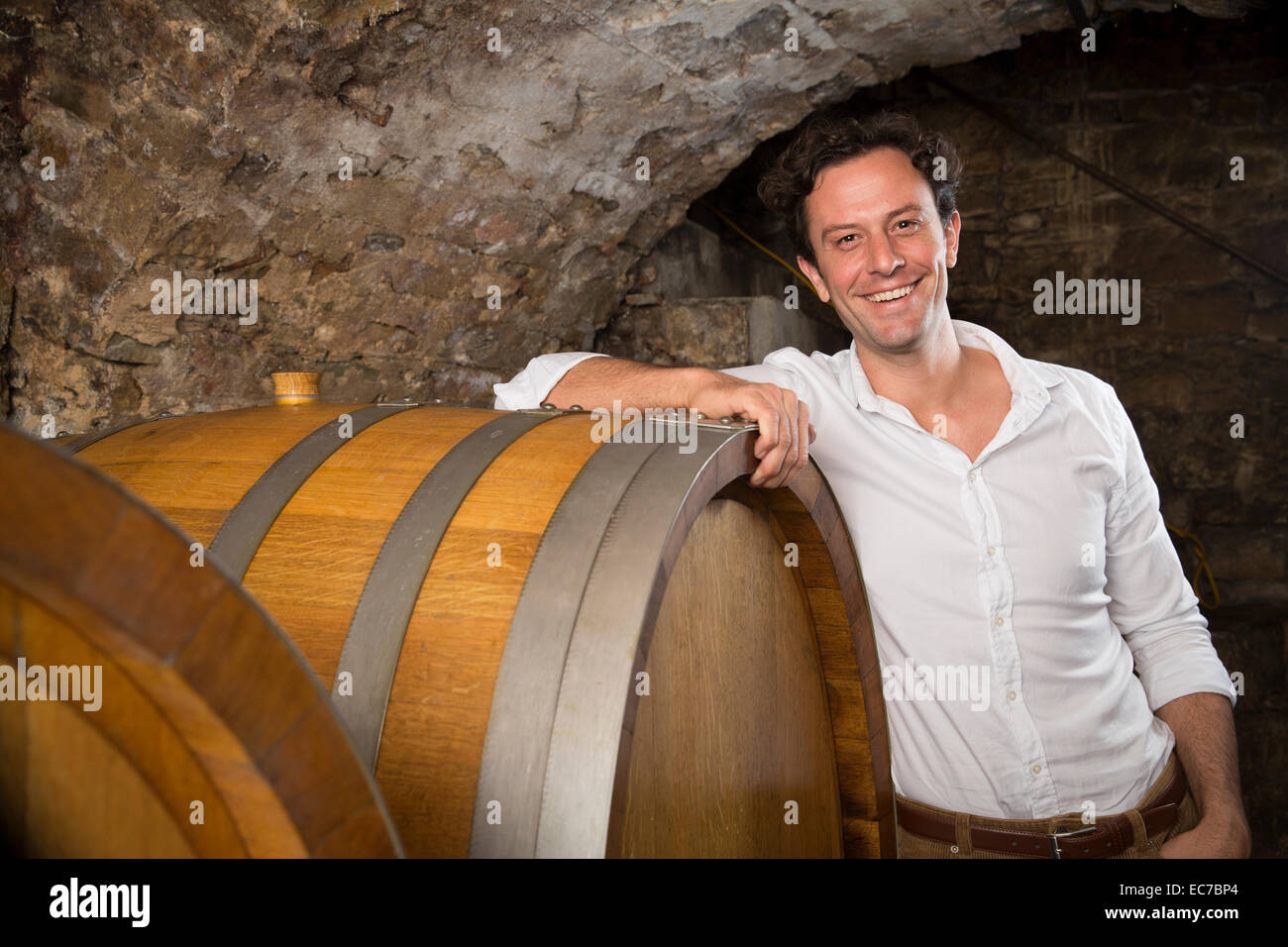 Portrait of smiling man in wine cellar Stock Photo - Alamy
