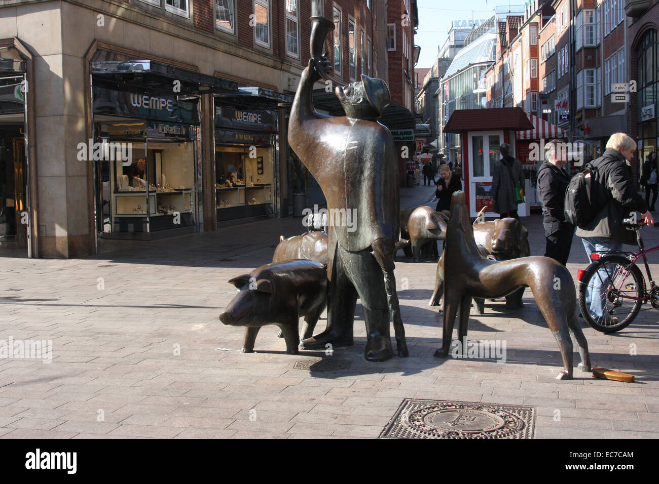 Bronze statues of a pig herdsman with his pigs in the Soege street. In the Middle Ages (sows = Soege) pigs were herded through the Soege street. Photo: Klaus Nowottnick Date: March 23, 2012 Stock Photo