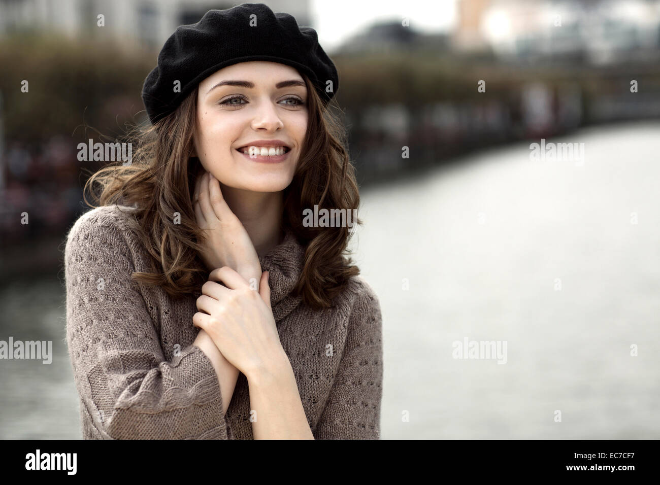 Portrait of happy young woman wearing beret and knitted dress Stock ...