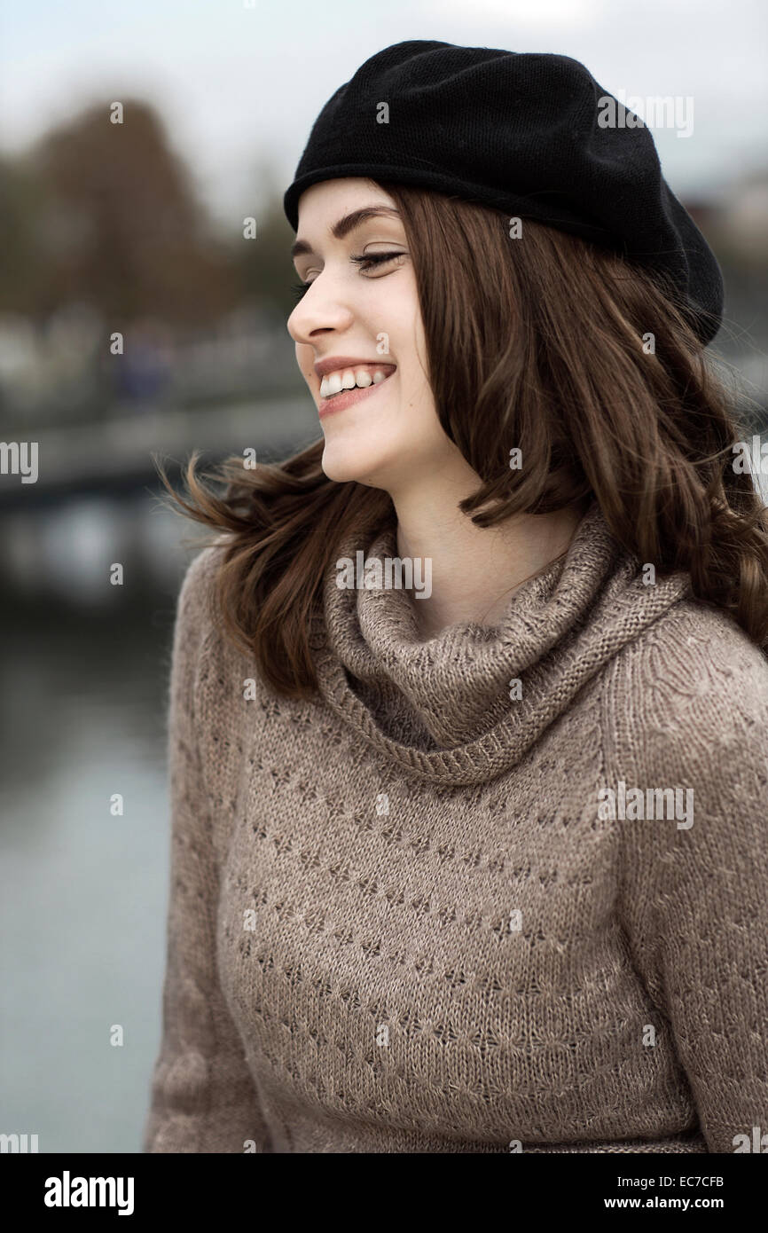 Portrait of smiling young woman wearing beret and knitted dress Stock ...