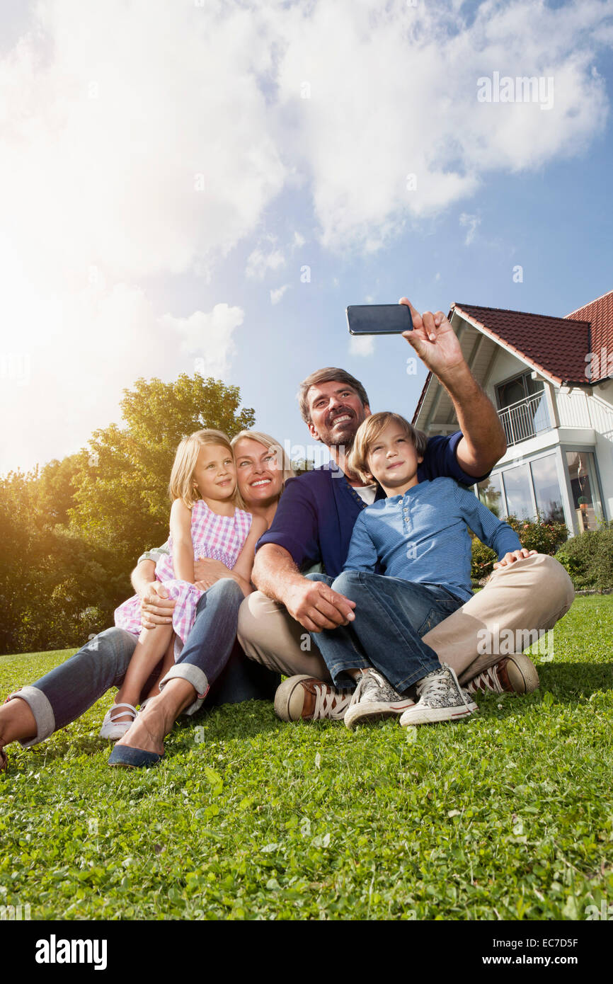 Happy family taking selfie in garden Stock Photo - Alamy