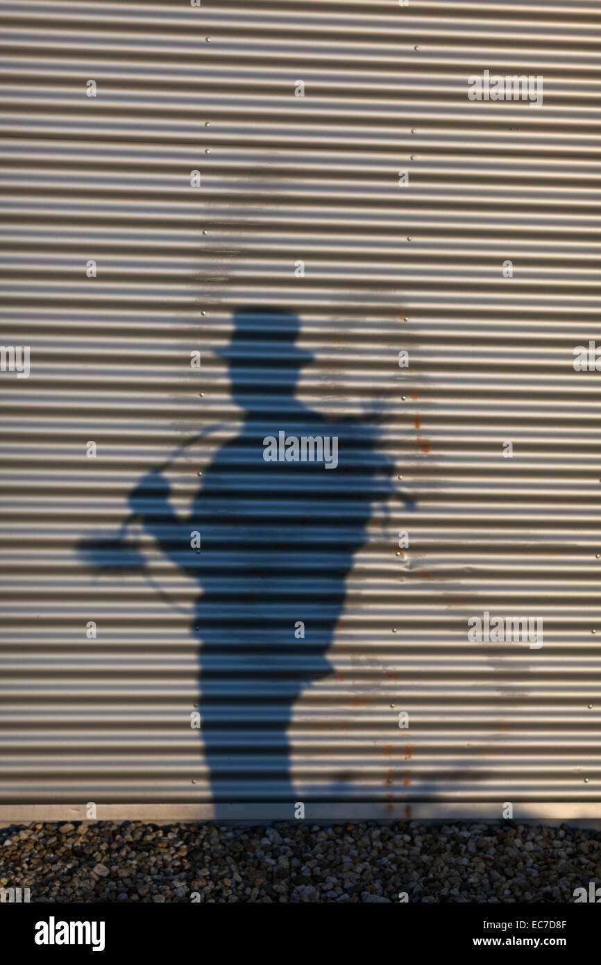 Germany, silhouette of chimney sweep on roller chutter Stock Photo