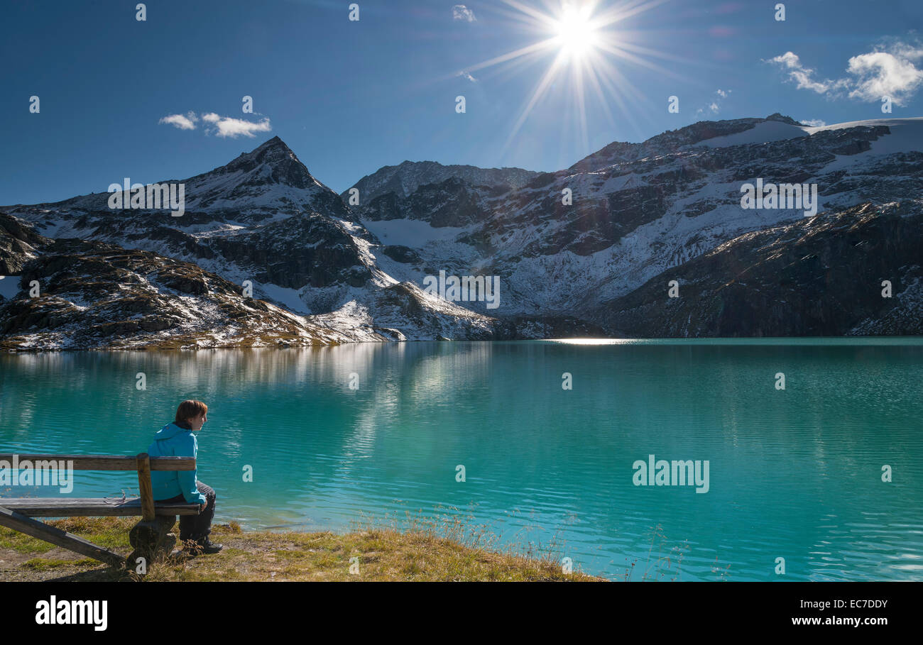 Austria, Salzburg State, Pinzgau, woman at Weisssee mountain lake Stock Photo