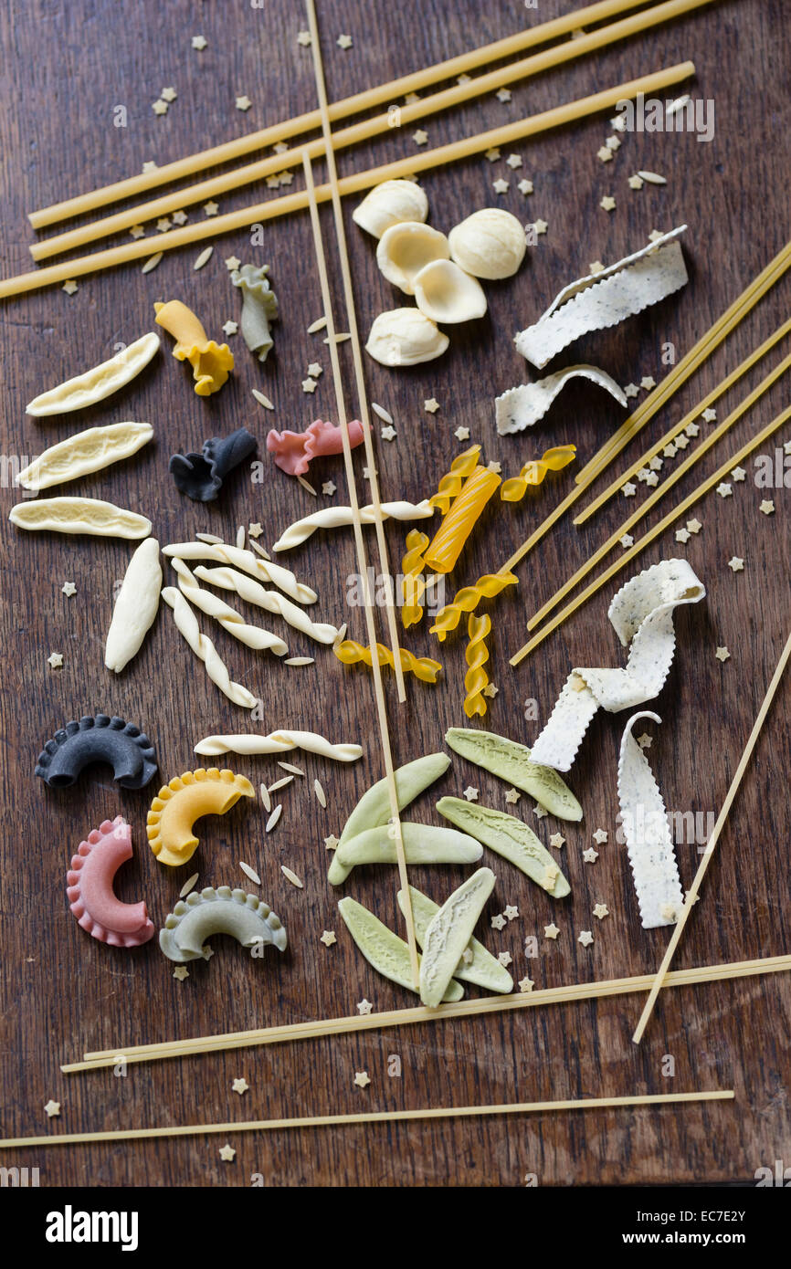 Different sorts of pasta on brown wood Stock Photo Alamy