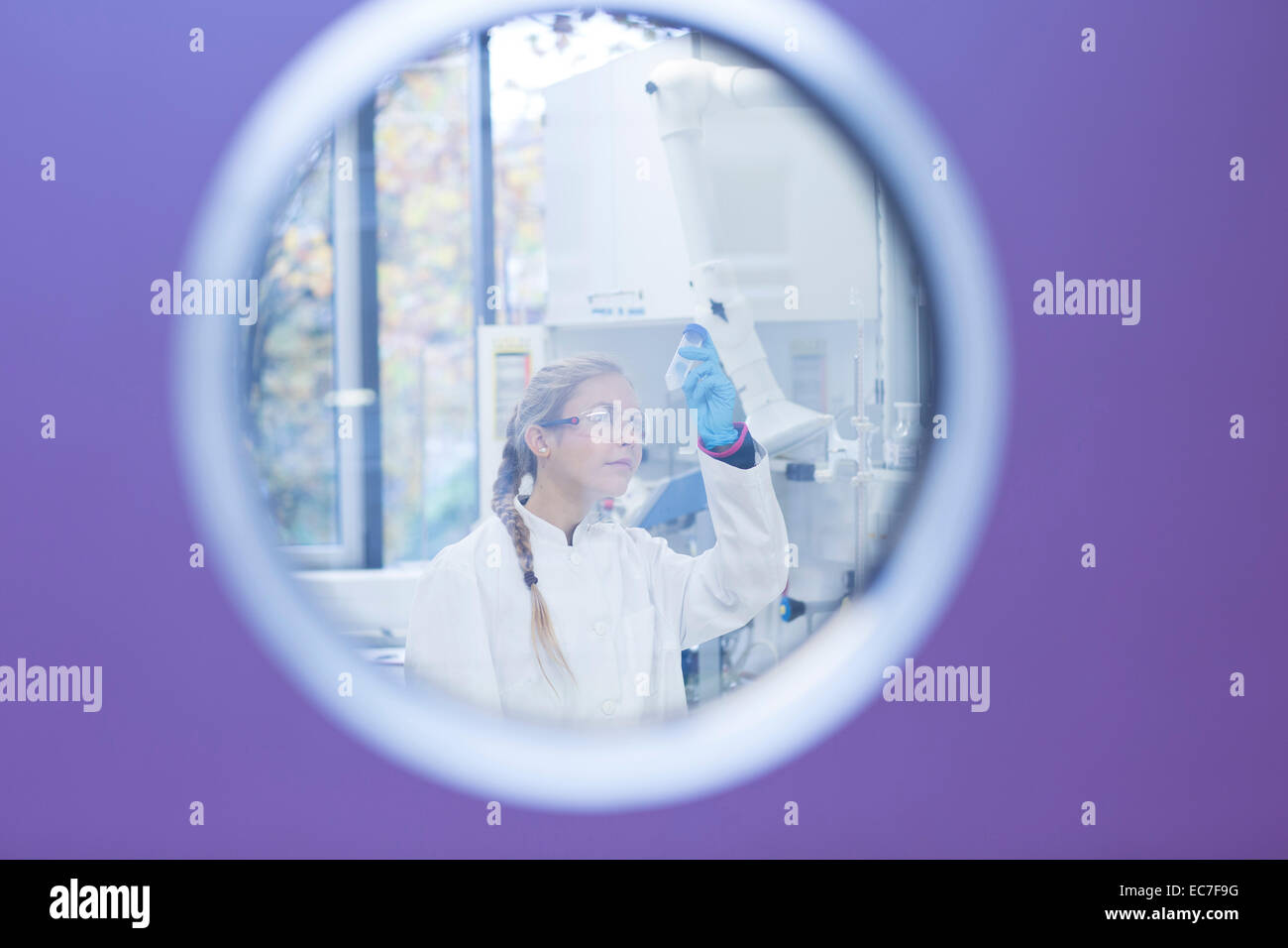Young female scientist working in a pharmacy research laboratory Stock