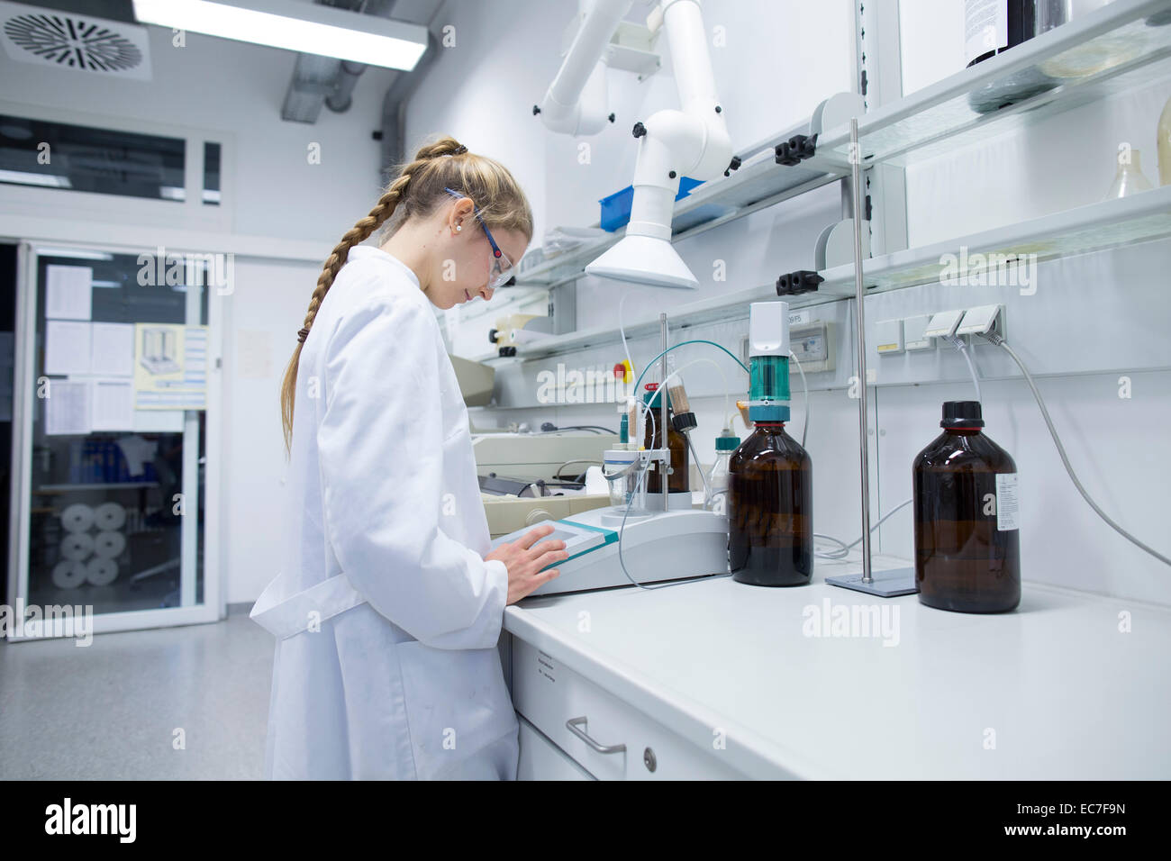 Young female scientist working in a pharmacy research laboratory Stock