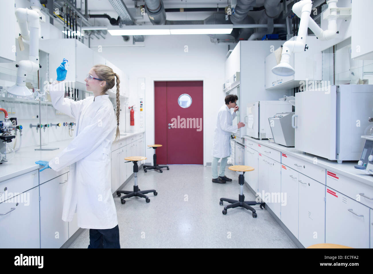Two female scientists working in a pharmacy research laboratory Stock