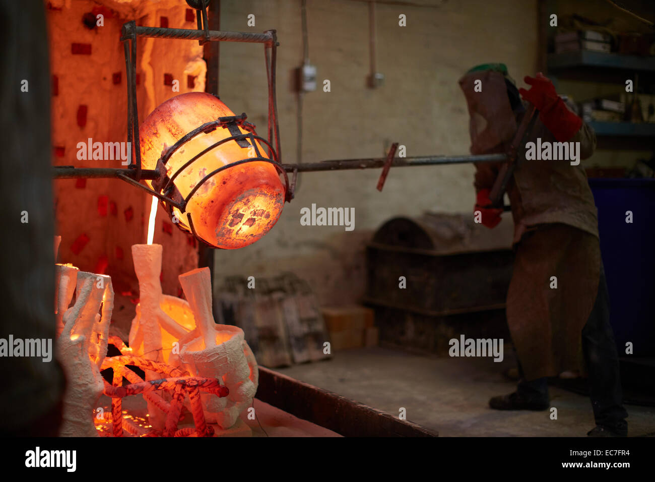 South Africa, Cape Town, Bronze being poured into casting mold Stock