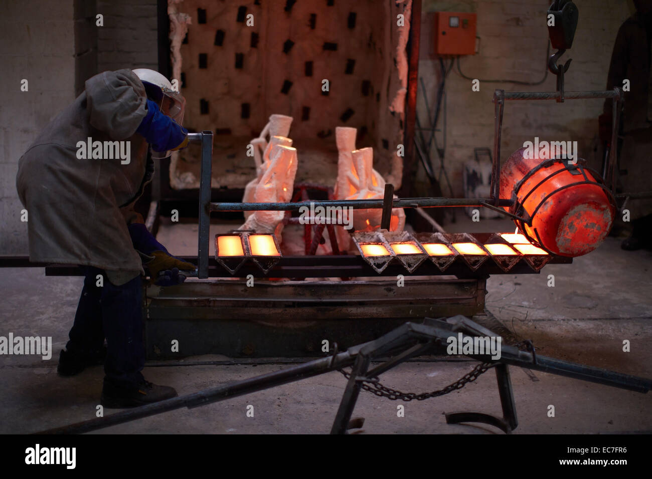 South Africa, Cape Town, Molten bronze being poured into shells for casting Stock Photo