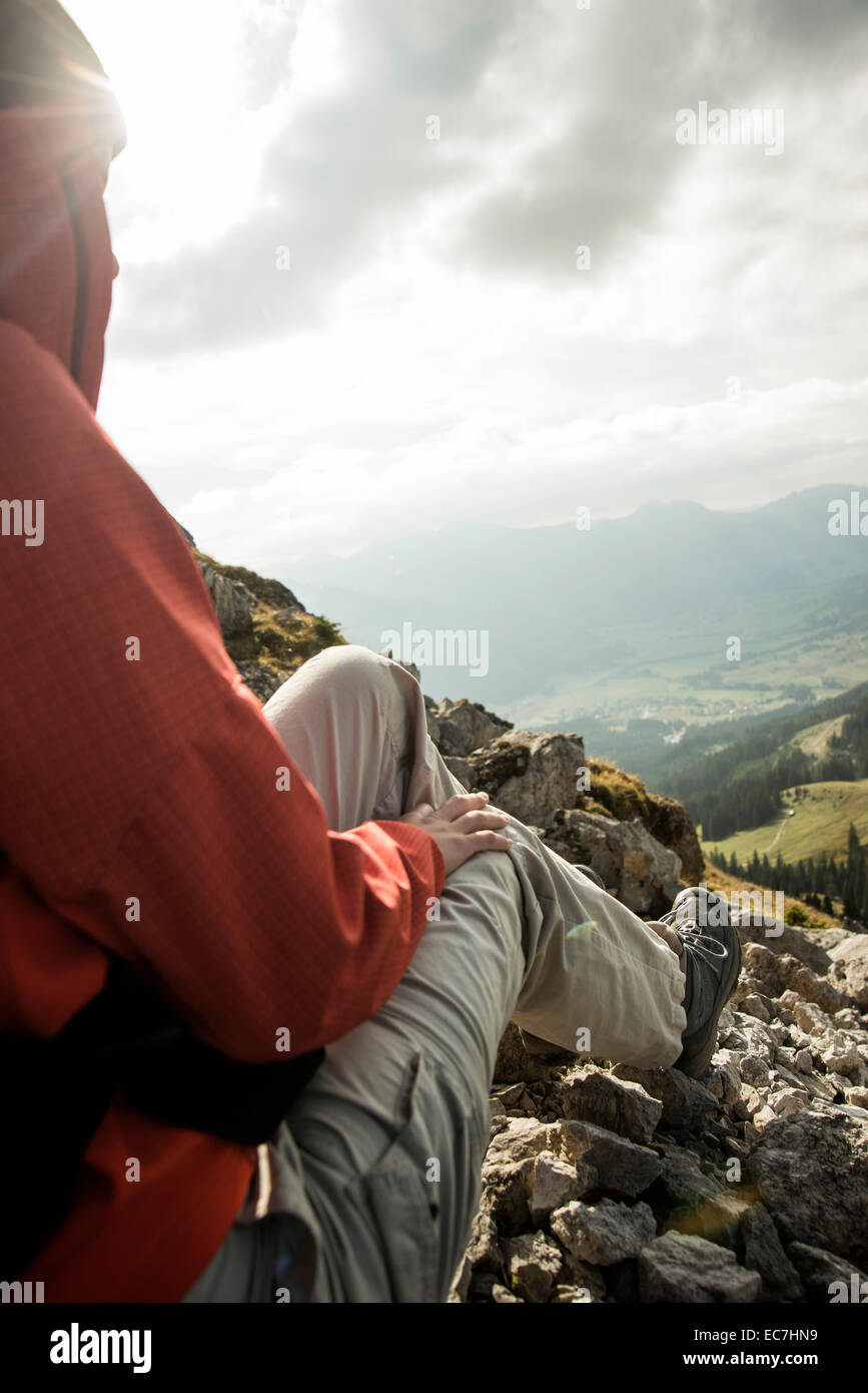 Austria, Tyrol, Tannheimer Tal, young female hiker having a rest in mountains Stock Photo