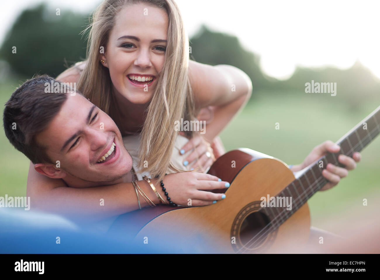 Portrait of happy teenage couple with guitar Stock Photo