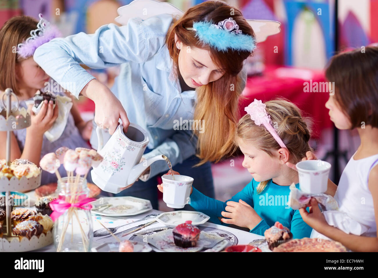 Girls and teenage girl on a tea party Stock Photo - Alamy