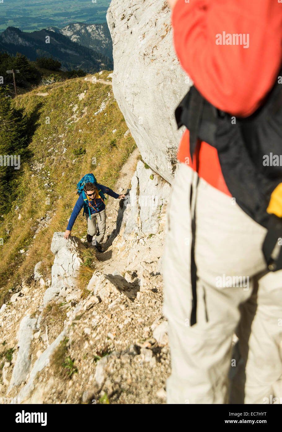 Austria, Tyrol, Tannheimer Tal, young couple hiking on rock Stock Photo
