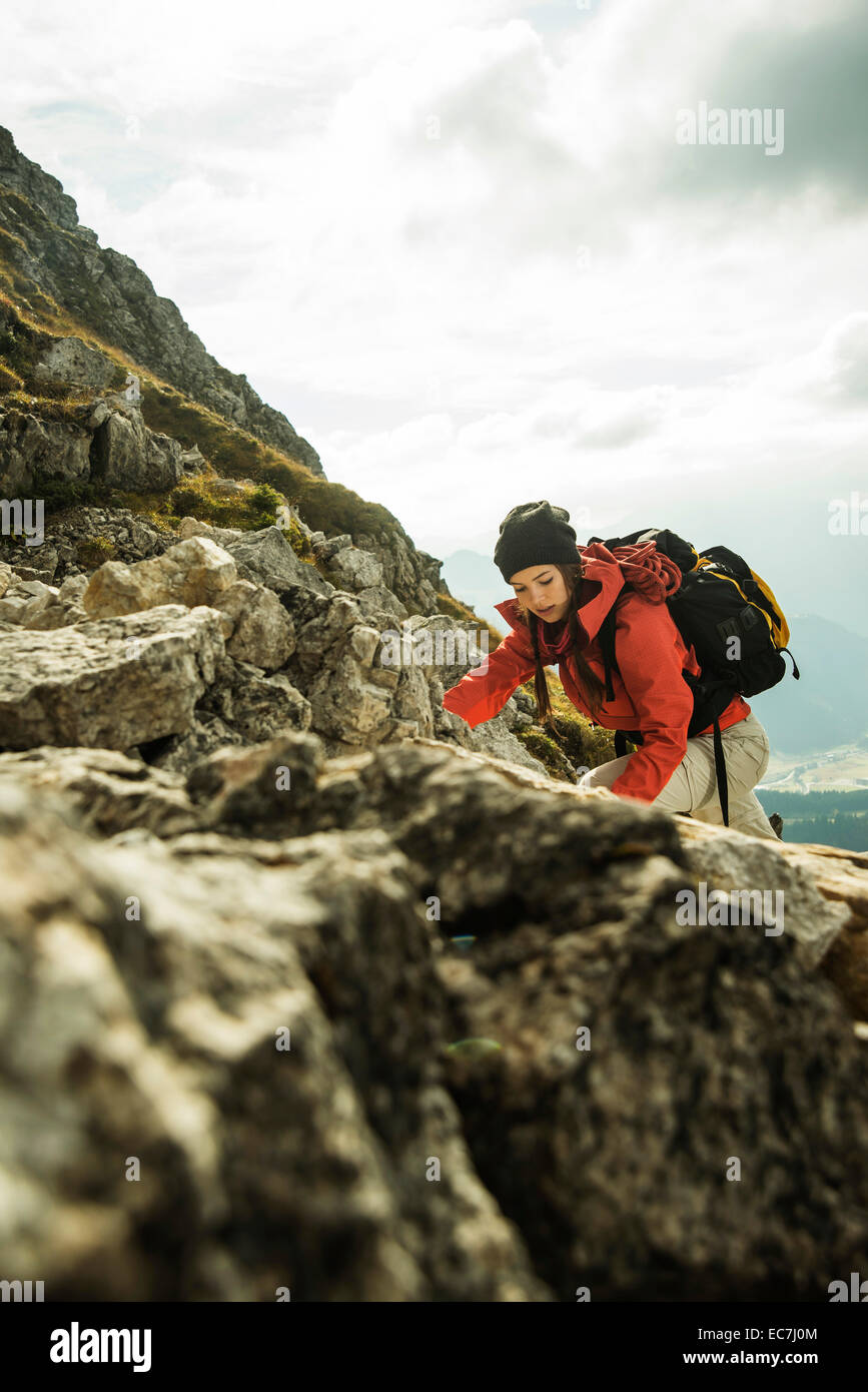 Austria, Tyrol, Tannheimer Tal, young woman climbing on rocks Stock Photo