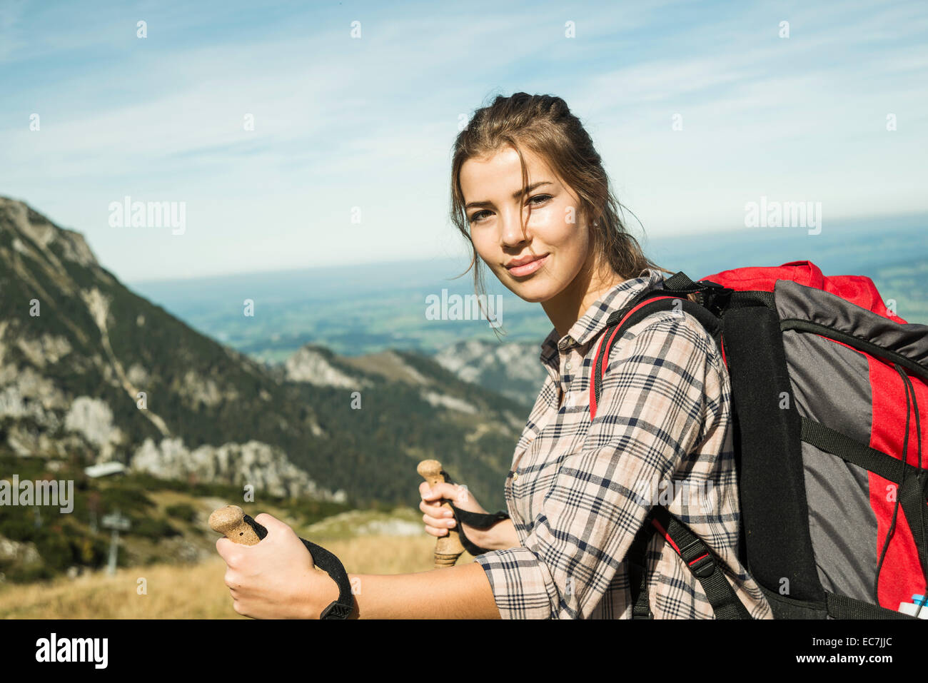 Austria, Tyrol, Tannheimer Tal, smiling young woman on hiking trip Stock Photo