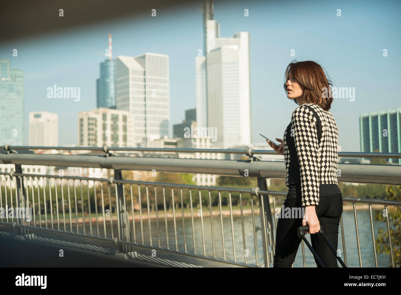 Germany, Frankfurt, young businesswoman on bridge Stock Photo