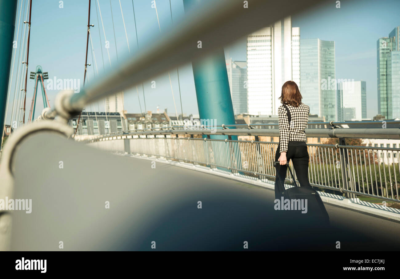 Germany, Frankfurt, young businesswoman on bridge Stock Photo