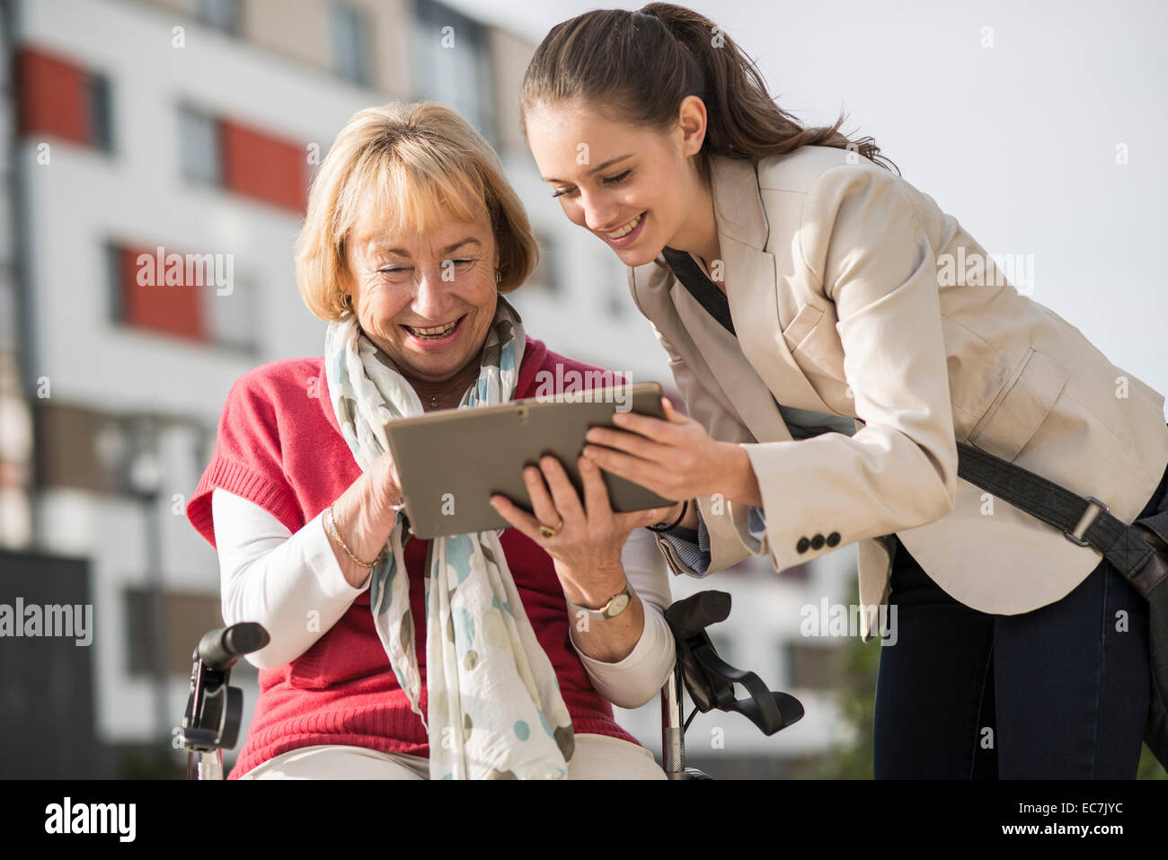 Granddaughter and her grandmother looking at digital tablet Stock Photo