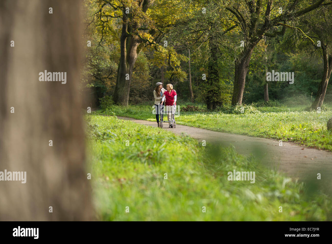 Senior woman and granddaughter walking together in a park Stock Photo